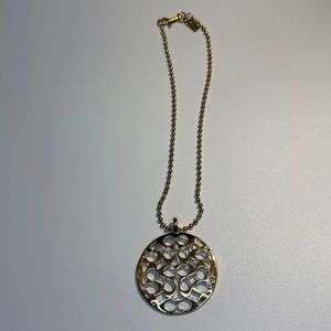 Gold C medallion necklace.